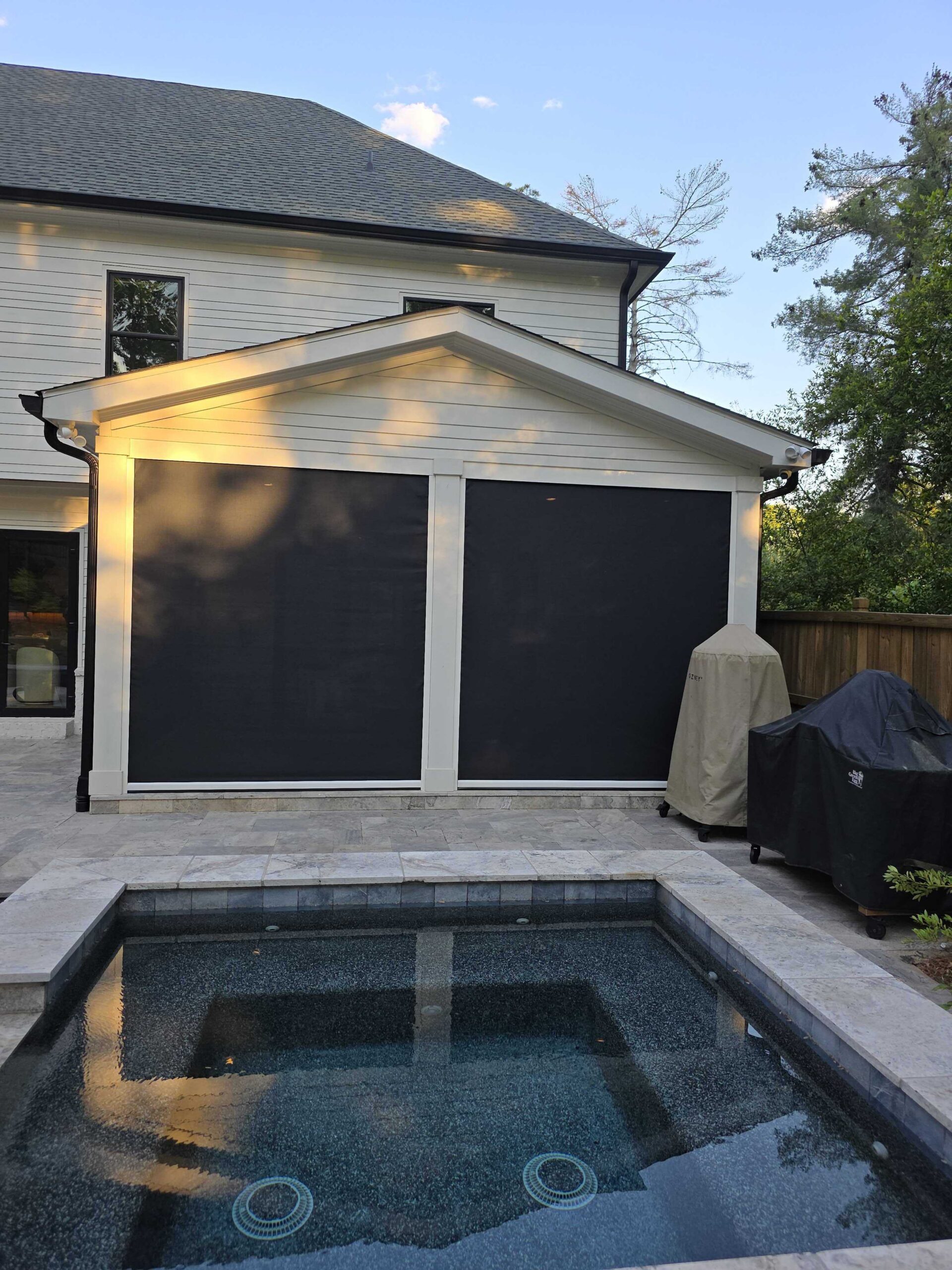 Poolside patio with two large motorized screens